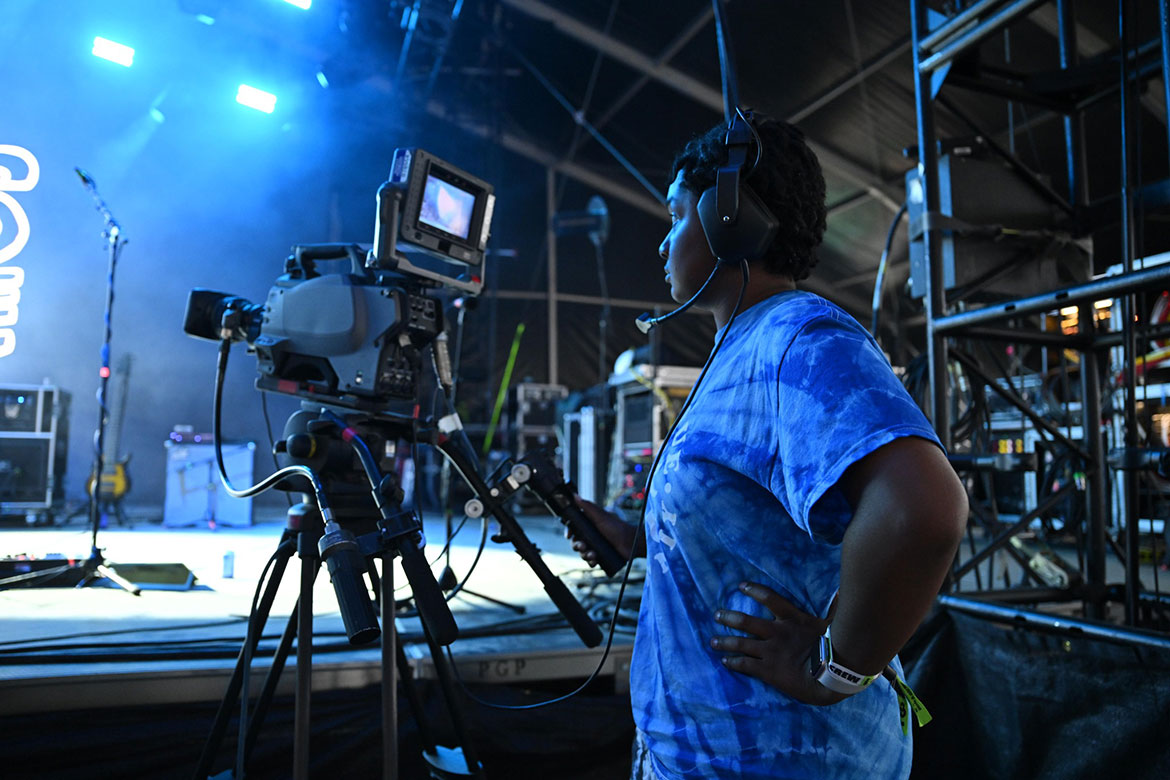 A student from Middle Tennessee State University’s College of Media and Entertainment works a cameras Thursday, June 12, at the 2025 Bonnaroo Music and Arts Festival in Manchester, Tenn. A team of about 50 students gained experience filming concerts, directing livestreams, creating social media content for university channels and writing stories before the four-day festival was cancelled Friday night, June 13, due to rain and additional weather concerns. (MTSU photo by James Cessna)