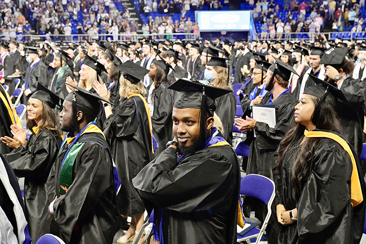 Members of MTSU's August Class of 2021 applaud their success after they "turn the tassels" on their mortarboards to signify their graduation during the university’s summer 2021 commencement ceremony Saturday, Aug. 7, in Murphy Center. MTSU presented degrees to 825 new graduates of the August Class of 2021 at the event. (MTSU photo by Andy Heidt)