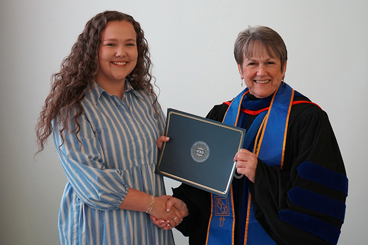 Middle Tennessee State University student and Phi Kappa Phi initiate Emma Dickey, left, is shown with Jones College of Business Dean Joyce Heames at the Spring 2026 initiation ceremony at the Paul W. Martin Sr. Honors Building. (MTSU photo by Robin E. Lee)
